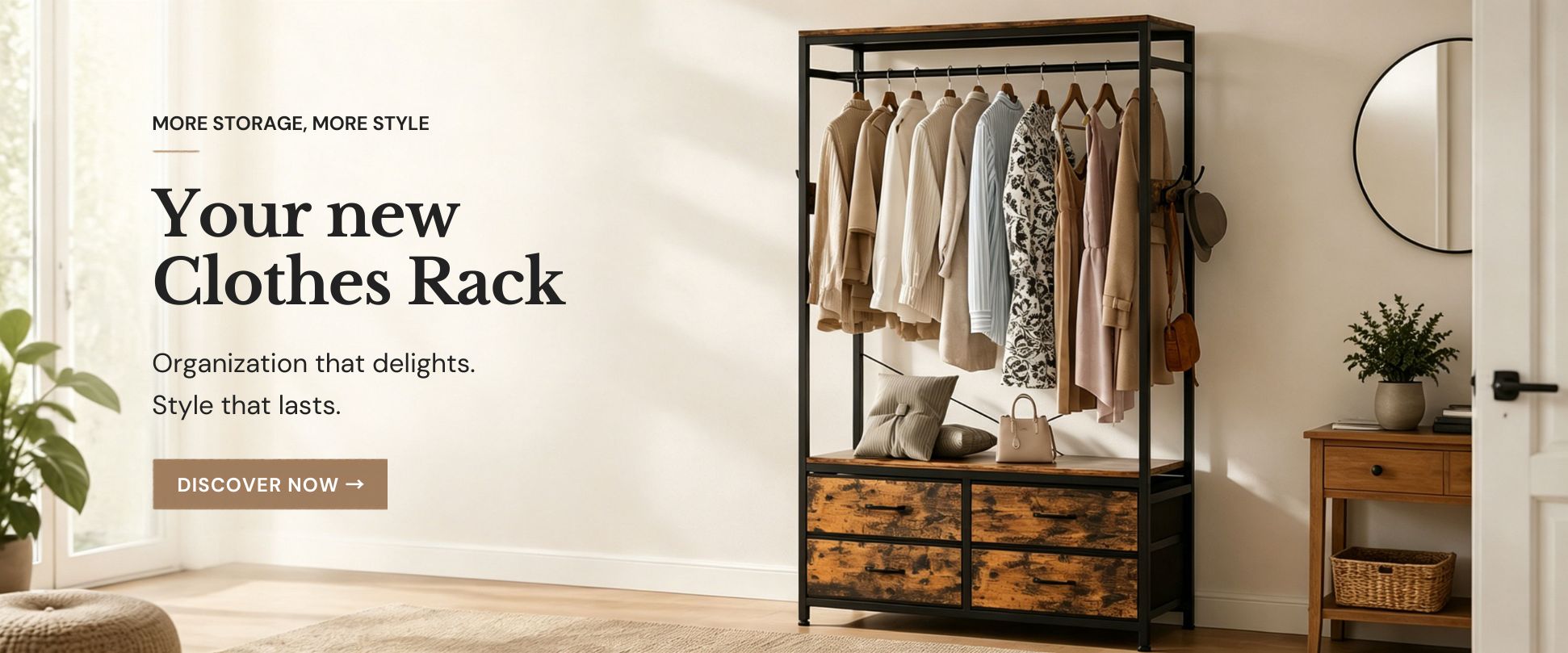 Modern metal and wood clothing rack with four drawers, holding several garments such as jackets, shirts, and dresses neatly. In the bright room, a plant is on the left and a wooden table with a basket and mirror on the right.